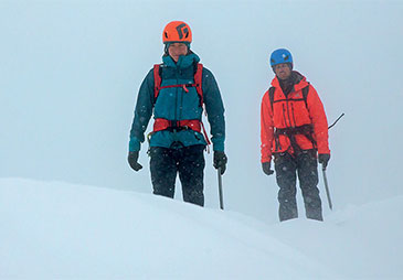 winter mountaineers looking ahead